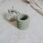 small jar in olive green color