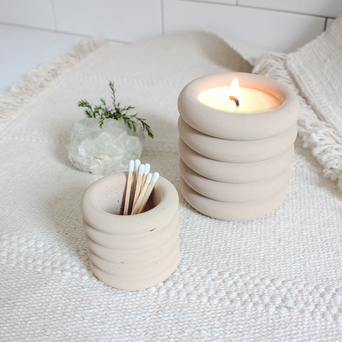 Mini ribbed jar holding matchsticks next to the regular sized ribbed jar
