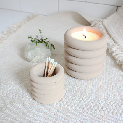 Mini ribbed jar holding matchsticks next to the regular sized ribbed jar