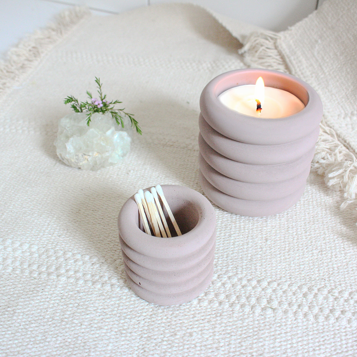 Mini ribbed jar holding matchsticks next to the regular sized ribbed jar