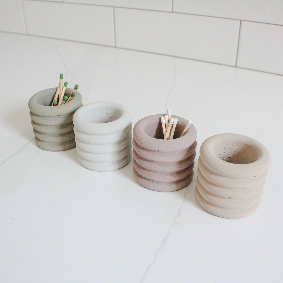 A thumbnail image of four assorted colored jars holding matches