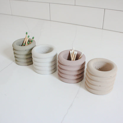 A thumbnail image of four assorted colored jars holding matches