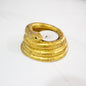 speckled gold snake candle holder on a white counter top